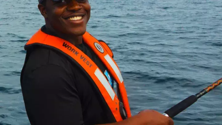 A man fishing on a boat.
