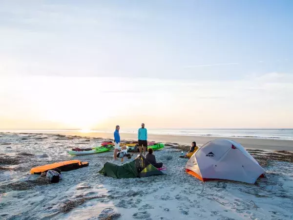 People camping on Little Tybee Island at sunset.