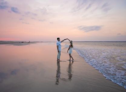 couple dancing on the beach at sunset