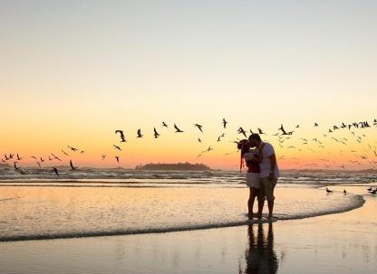 Couple kissing on the beach at sunset