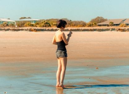 A woman standing on the beach.