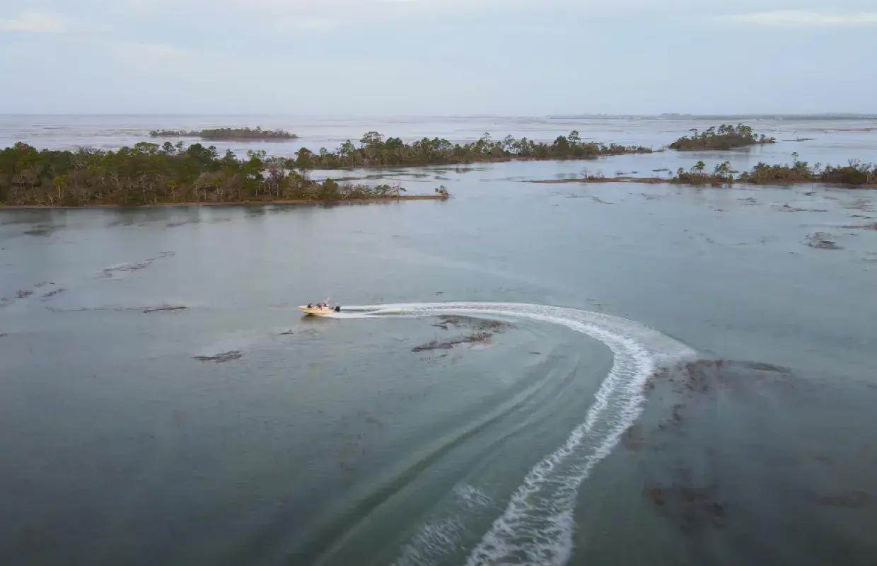 A small charter boat sailing along Tybee Island, GA.