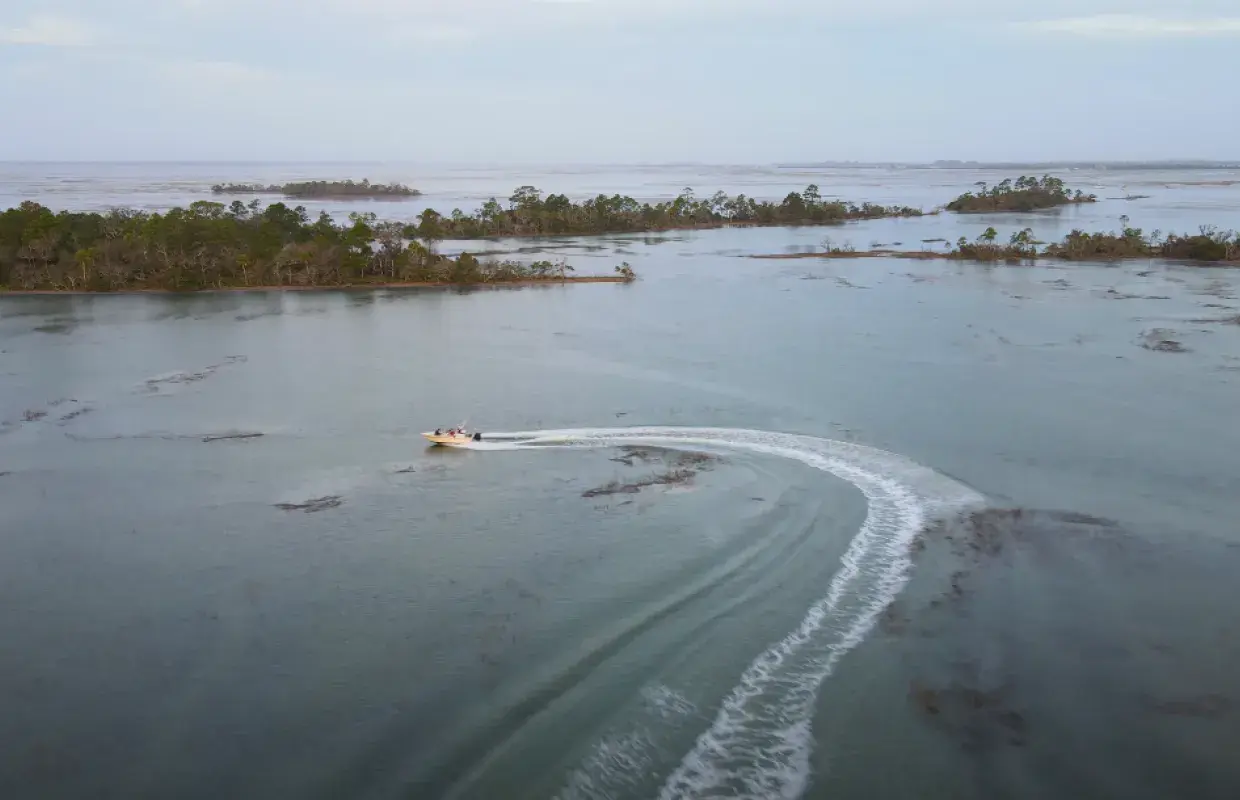A small charter boat sailing along Tybee Island, GA.